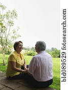 Senior Hispanic couple sitting outdoors together Senior Hispanic couple sitting outdoors together