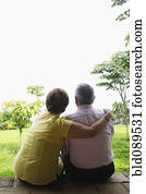 Senior Hispanic couple sitting outdoors together Senior Hispanic couple sitting outdoors together