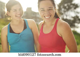 Athletic women smiling together outdoors