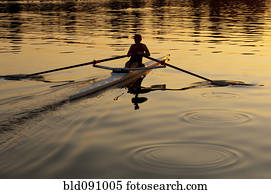 Person rowing sculling boat on river