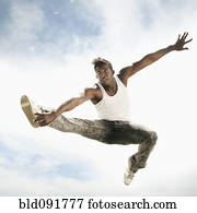 African American man jumping in mid-air