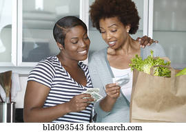 African American mother and daughter reviewing grocery bill