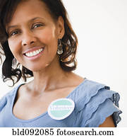 Black woman wearing volunteer badge Black woman wearing volunteer badge