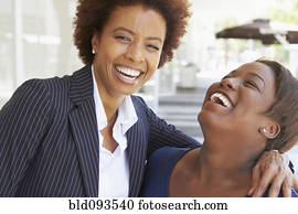Laughing African American mother and daughter