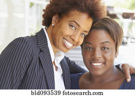Smiling African American mother and daughter