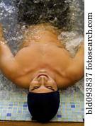 Hispanic man soaking in hot tub