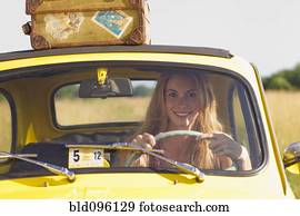 Caucasian woman driving car on road trip