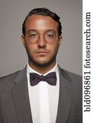 Serious Caucasian man in suit and bow tie