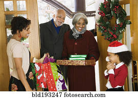 African American grandparents arriving with Christmas gifts