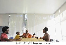 Black family eating at dining room table