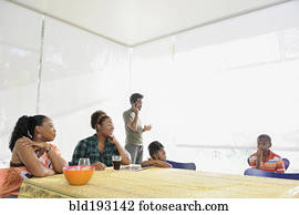 Black family eating at dining room table