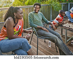 Black family relaxing on patio