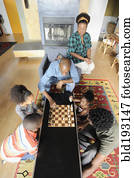 Black family watching chess game