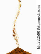 Brown powder pouring into pile