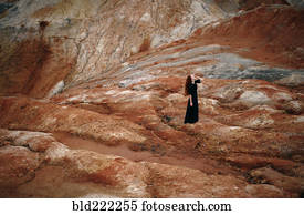 Caucasian woman walking on rock formation