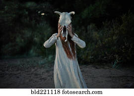 Caucasian woman wearing animal skull