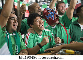 Cheering men watching television in sports bar