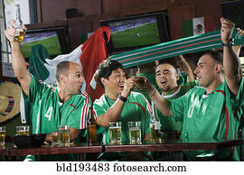 Cheering men watching television in sports bar