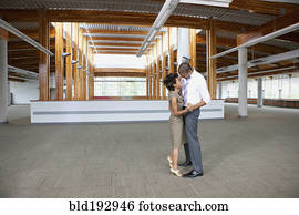 Couple dancing in empty office space