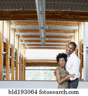 Couple laughing in empty office space