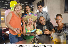 Friends celebrating birthday in cafe