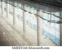 Reflection of window and pillars on shiny floor