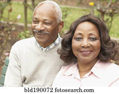 Senior African couple hugging and smiling outdoors Senior African couple hugging and smiling outdoors