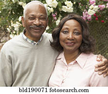 Senior African couple hugging and smiling outdoors Senior African couple hugging and smiling outdoors