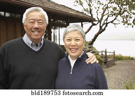 Senior Asian couple smiling and hugging outdoors Senior Asian couple smiling and hugging outdoors