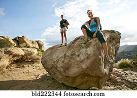 Women standing on rock formation