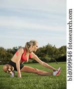 Caucasian woman stretching before exercise