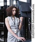 Black businesswoman working in server room