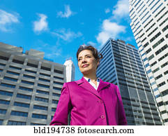 Caucasian Businesswoman standing in city
