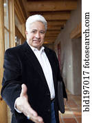 Hispanic businessman holding out hand