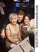 Man photographing friends in restaurant