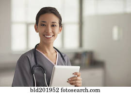 Mixed race nurse holding digital tablet