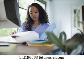 Mixed race woman looking at paperwork