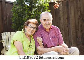 Senior Hispanic couple sitting together outdoors Senior Hispanic couple sitting together outdoors