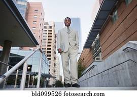 African American businessman standing at top of stairs