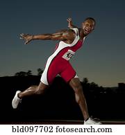 Black runner crossing finish line in race