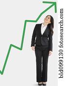 Japanese businesswoman looking at green arrow