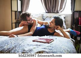 Carefree couple relaxing on bed