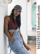 Casual Mixed Race woman leaning on wall