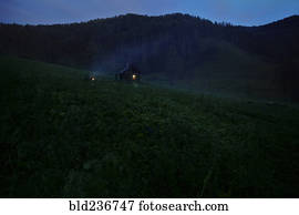 Distant house on hill at night