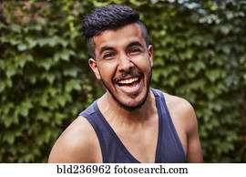 Laughing Middle Eastern man wearing tank-top