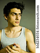 Pensive Mixed Race man wearing tank-top