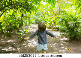 Carefree Caucasian boy standing on path