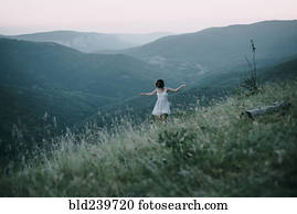 Carefree Caucasian woman walking on mountain
