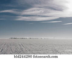 Clouds over distant winter landscape
