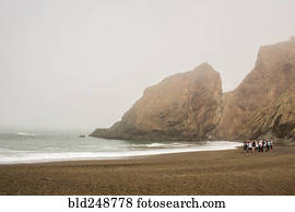 Distant crowd of people standing on beach